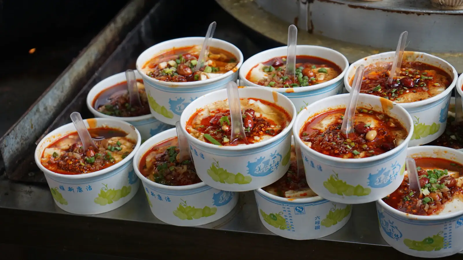 Spicy Sichuan street food dishes at a night market stall
